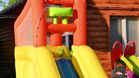 Inflatable slide with flowing water stands outdoors Stock Footage 331856377