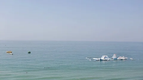 Inflatable Slide In The Ocean. Wide Shot Video stock 123701824