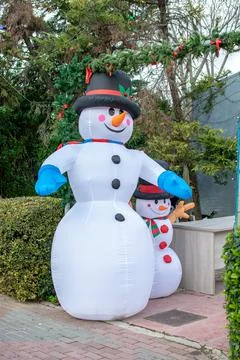 Inflatable snowman with a smaller one next to him. Stock Photos