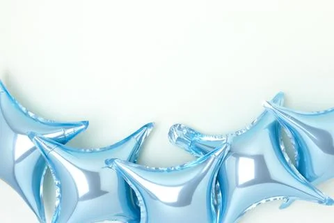 Inflatable star balloons on a blue background. Stock Photos