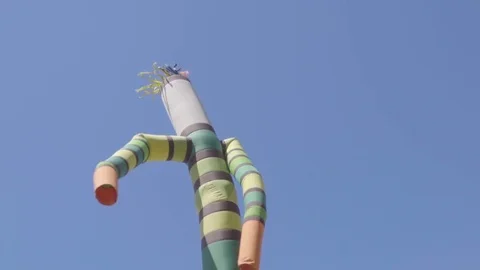 Inflatable striped man dances against the blue sky. Stock Footage 77118101