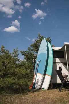 Inflatable Sup rowing boards stand near the motorhome inflated in nature du.. Stock Photos