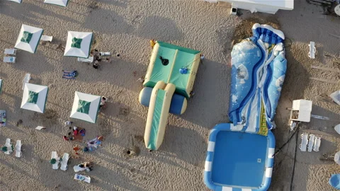 An inflatable trampoline is carried to the shore Stock Footage 146249921
