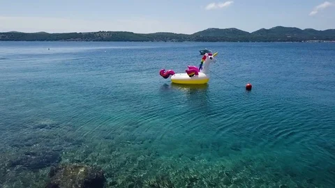 Inflatable unicorn floating on water Stock Footage 113042479