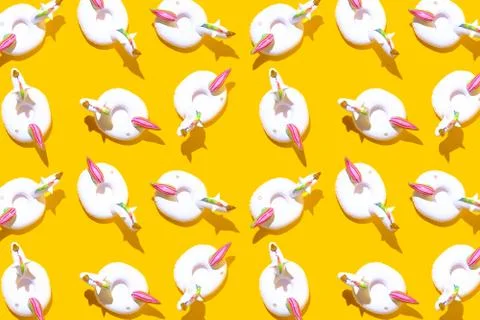 Inflatable unicorn pool toy pattern on yellow background. Minimal summer conc Stock Photos