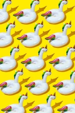 Inflatable unicorn pool toy pattern on yellow background. Minimal summer conc Stockfoto's