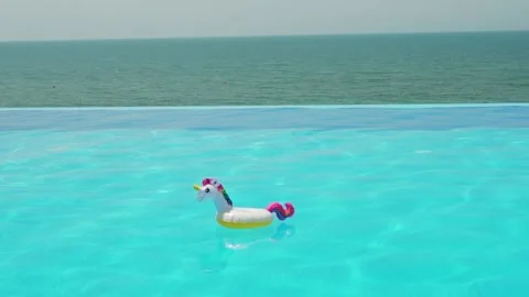 Inflatable Unicorn Toy in Infinity Beach Pool with Sea View, Nobody. Stock Footage 198141344