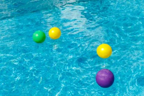 Inflatable water fun balls float on the water in the pool. Concept, cheerful, Stock Photos