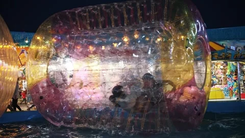 Inflatable Water Roller. Water attractions. Flashing light. Children playing Stock Footage 246276059
