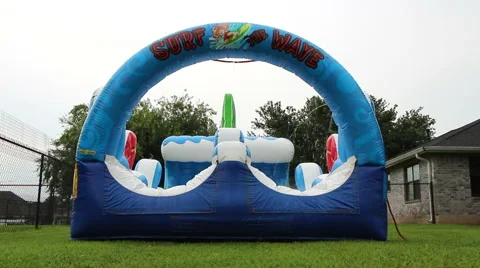 Inflatable Water Slide in Backyard in Summer Stock Footage 50938646