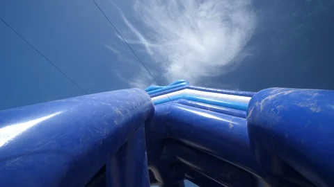 Inflatable Water slide on the Sandy beach in Europe. Summer warm day blue Sky. Vídeos de archivo 128595374