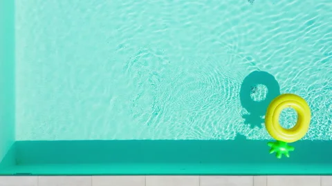 Inflatable yellow ring floating in swimming pool in summer resort.  Stock-Footage 221786371
