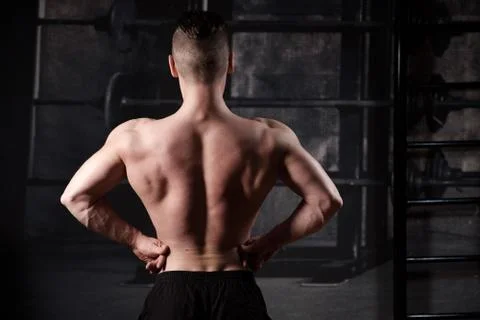 Inflated guy with a naked torso stands with his hands on his belt, a frame from Foto stock