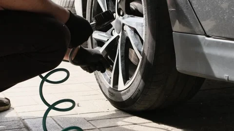 Inflating car wheels. Checking the air pressure in a car wheel. Stock Footage 270977301
