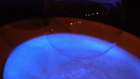 Inflating a huge soap bubble. Water experiments. Stock Footage 194132677