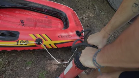 Inflating pump air into inflatable raft boat water sport outdoor activity Vídeo Stock 331425230