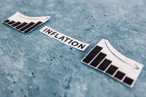 Inflation text in between graphs with stats going up then going down, economi Stock Photos