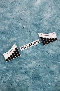 Inflation text in between graphs with stats going up then going down, economi Stock Photos