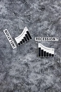 Inflation text next to graphs with stats going up  and recession text next to Stock Photos