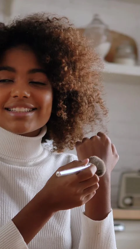 Influencer with afro hair testing new blush on hand for beauty vlog, blogger Stock Footage 345020253