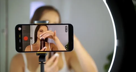 Influencer Applies Serum in Front of Camera at Home Stock Footage 323445491
