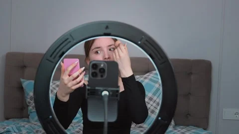 Influencer applying makeup with ring light and mirror Stock Footage 311781002