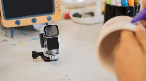 Influencer creating art workshop content with an action camera, setting on .. Stock Photos