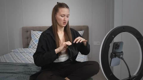 Influencer creating content with a ring light and smartphone Stock Footage 308309059