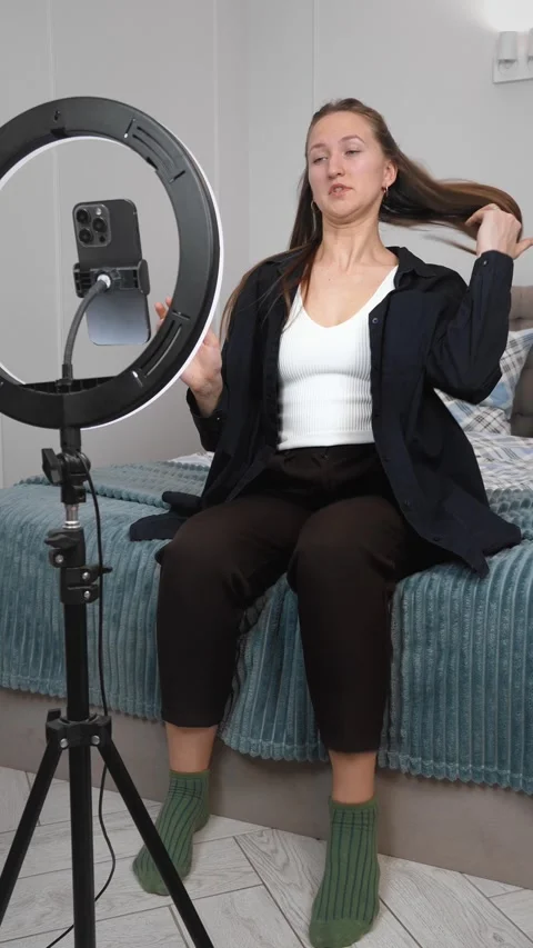 Influencer creating engaging content for social media with ring light Stock Footage 308233874
