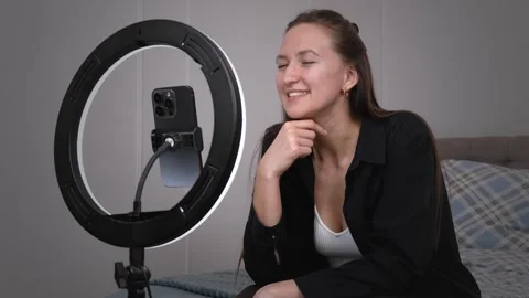Influencer creating engaging content for social media with ring light Stock Footage 308236221