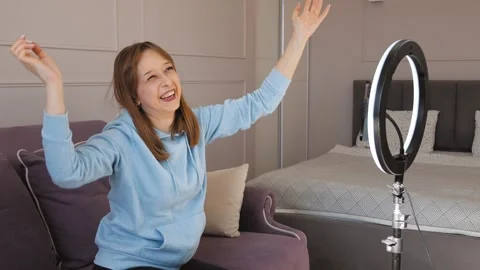 Influencer recording video content on smartphone with ring light at home 스톡 동영상 314611341