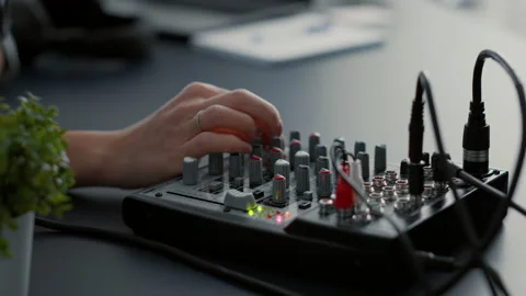 Influencer tweaking audio mixer knobs and buttons 스톡 동영상 219898865