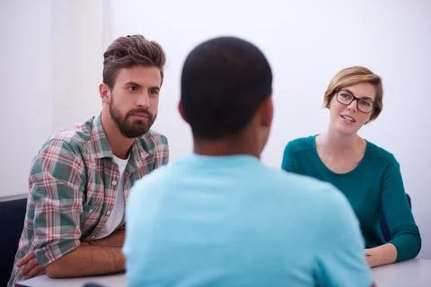 An informal business meeting. A group of informal businesspeople in a meeting. Stock Photos