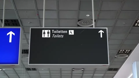 Information boards in airport hall with pointer icons, arrow, WC. Toilet pointer Stock Footage 274535083
