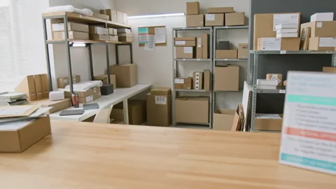 Information Leaflet and Racks with Parcels at Express Delivery Company Stockbeeldmateriaal 321433452