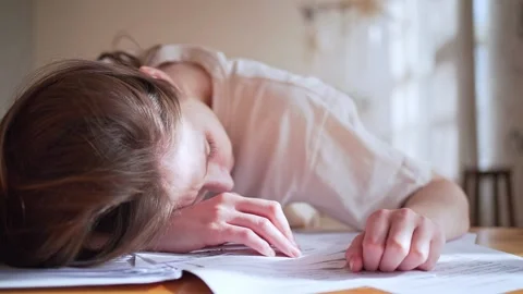 Information overload. The woman sleeps on the documents. Stress and fatigue at Видео 147919102