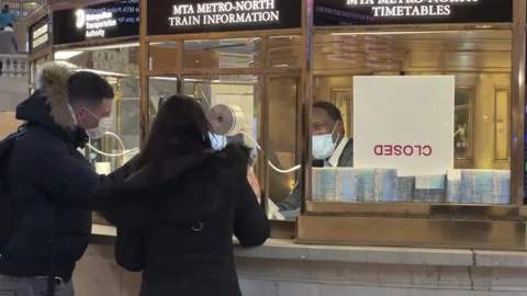 Information person at help desk helping travelers in Grand Central Station NYC Stock Footage 169931933