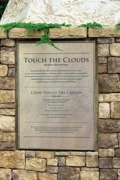 Information plaque on Chief Touch the Clouds sculpture, Edmond. Stock Photos
