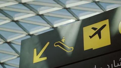 Information pointer in airport with yellow symbol of arrow, plane and escalator Stock Footage 230845918