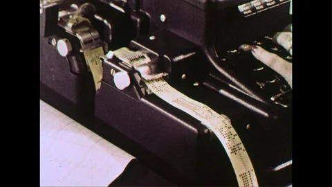 Information is punched into a roll of paper at a register. Video stock 74451779
