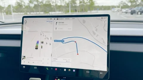 The information screen with a Tesla Santa sleigh and raindeer on a Tesla Stock Footage 324592912