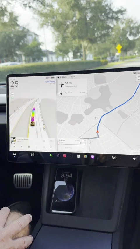 The information screen with a Tesla Santa sleigh and raindeer on a Tesla Stock Footage 324592913