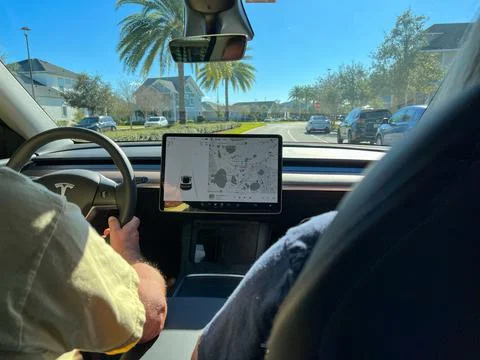 The information screen on a Tesla while driving. Stock Photos
