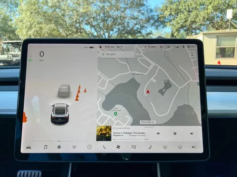 The information screen on a Tesla while driving. Stock Photos