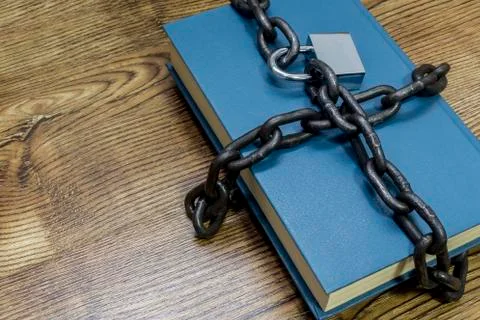 Information security concept, book with chain and padlock. Stock Photos