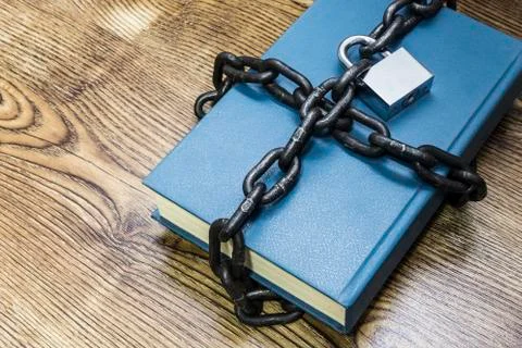 Information security concept, book with chain and padlock. Stock Photos