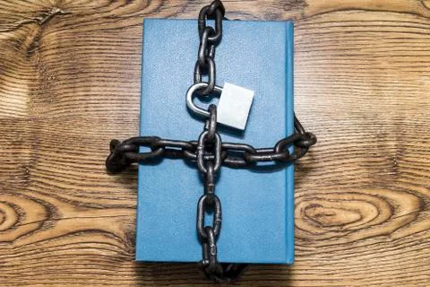 Information security concept, book with chain and padlock. Stock Photos