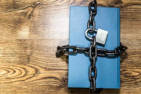 Information security concept, book with chain and padlock. Stock Photos