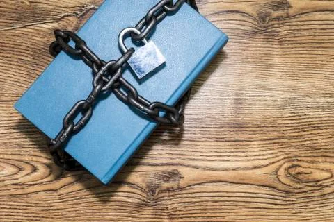 Information security concept, book with chain and padlock. Stock Photos