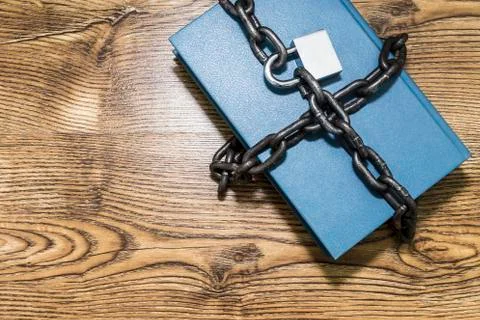 Information security concept, book with chain and padlock. Stock Photos